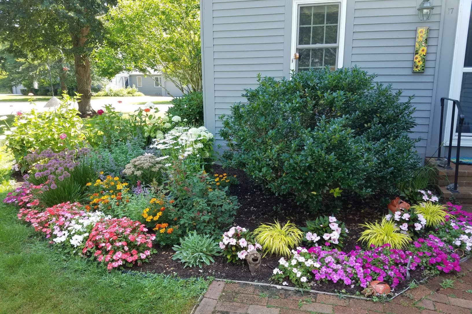 A colorful foundation garden beside a home
