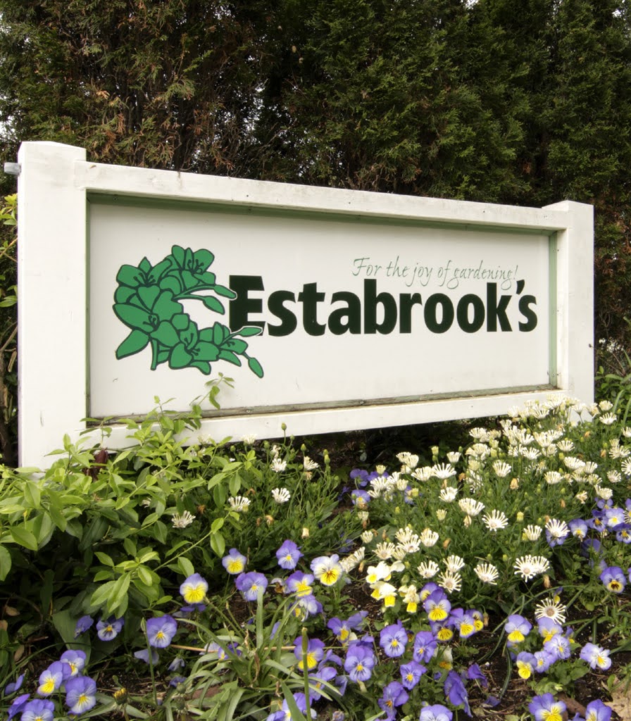 Historic Estabrook's sign surrounded by flowers