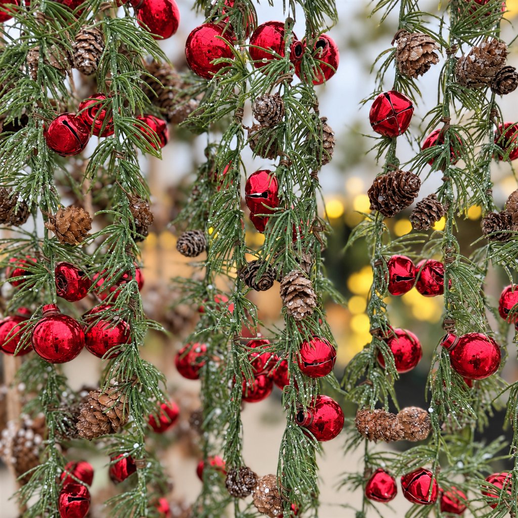 Faux evergreen garlands with red bells and pinecones