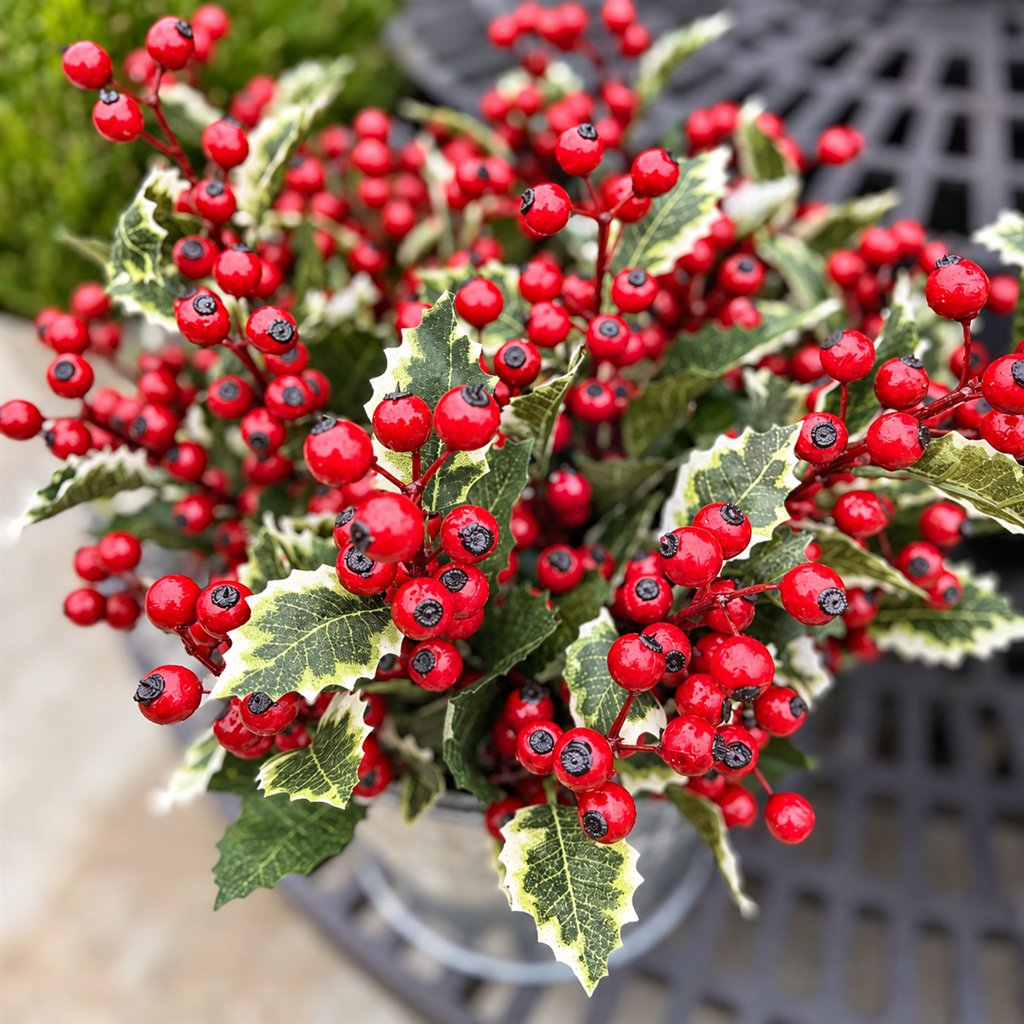 Artificial red holly berries with variegated green leaves