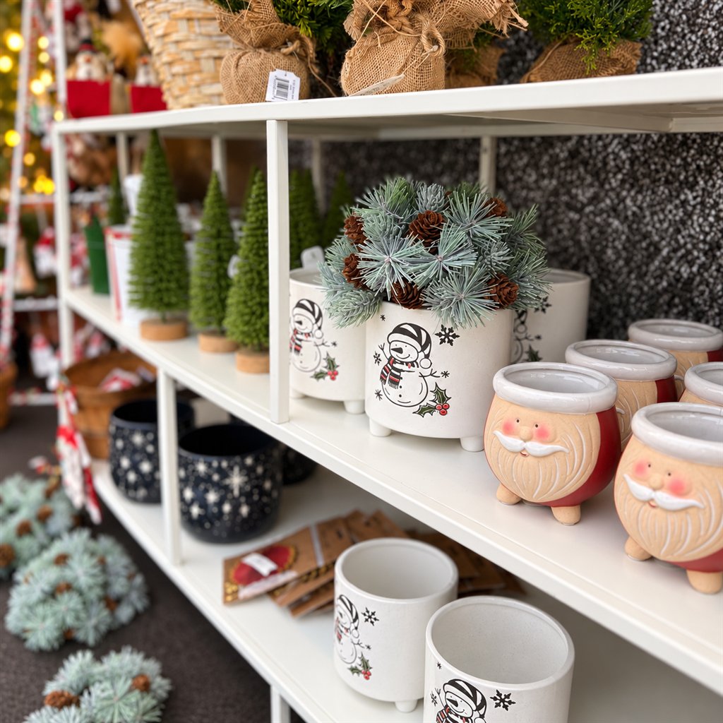 Santa and snowman holiday planters on display