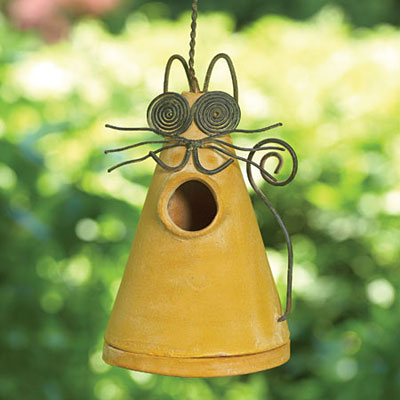 Decorative yellow metal birdhouse for the garden