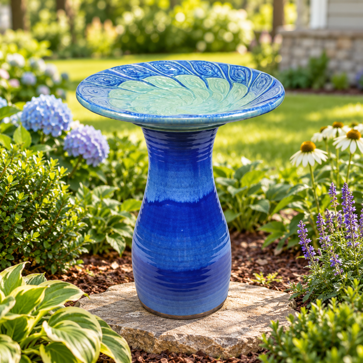 Blue glazed birdbath in a garden